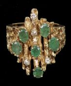 An unmarked, possibly 14 ct gold, diamond and emerald ring
Of bark textured finish, set with six