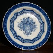 An 18th century Delft plate
Decorated in blue and white with central floral urn.  30 cms diameter.