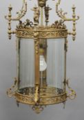 An ornate brass framed hall lantern
The scroll cast frame enclosing the four curved bevelled glass