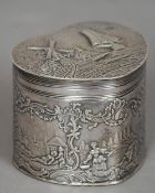 A Dutch 925 silver trinket box
Of embossed heart form, decorated with figures and shipping
