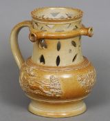 A 19th century Derbyshire salt glazed brown stonewear puzzle jug
With reticulated neck and triple