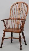 A 19th century elm seated Windsor chair
The hoop back above a pierced central splat and turned