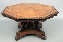 A 19th century carved oak octagonal tilt top centre table
The segmented top with a carved frieze