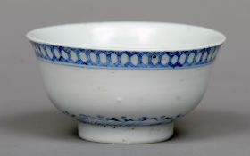 A Japanese blue and white porcelain bowl
Decorated with a geometric band above stylised waves, six