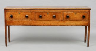 A George III oak low dresser
The moulded rectangular top above three frieze drawers, supported on