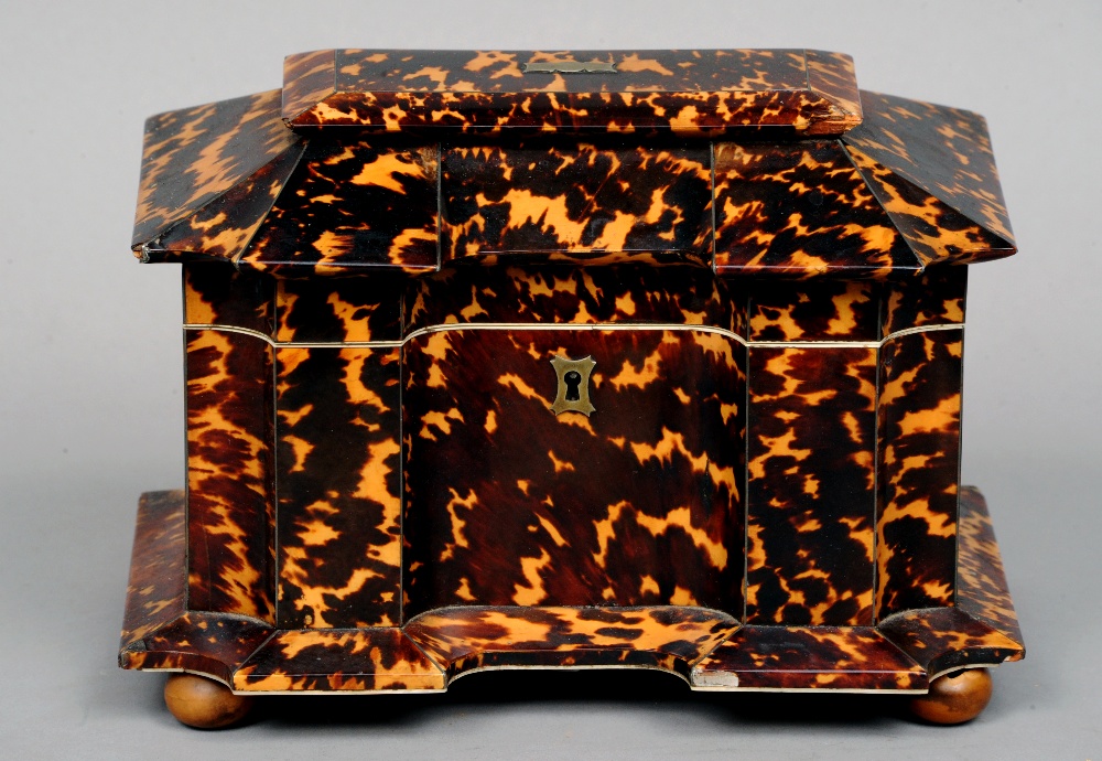 A 19th century tortoiseshell tea caddy
The shaped rectangular hinged top enclosing two lidded