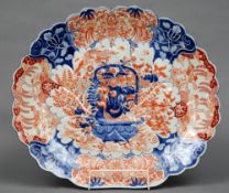 A late 19th century Japanese Imari charger
Of scallop form, decorated with a flowering urn amongst