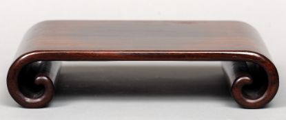 An 18th century Chinese finely carved hardwood scroll stand
Of typical form with scroll ends.  37