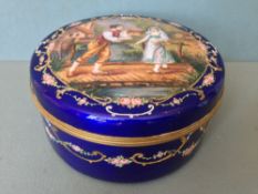 A large 19th century Continental enamel decorated box
Of circular form with removable lid