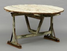A 19th century French painted pine harvest table
The removable circular top above the trestle