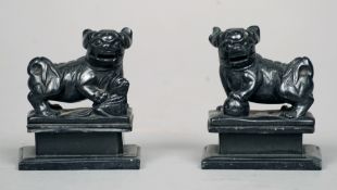 A pair of Chinese carved hardstone models of dogs-of-fo
Each modelled standing on all fours, on a