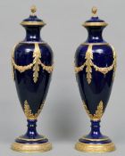 A pair of ormolu mounted Sevres style cobalt blue ground porcelain vases
Each domed top with a