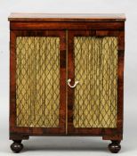 A Regency rosewood side cabinet
The crossbanded rectangular top above twin brass grille mounted