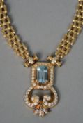 An 18ct gold diamond, aquamarine and sapphire set necklace
The centrally set aquamarine bordered