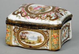 A 19th century Continental painted porcelain dressing table box
The shaped hinged lid decorated with