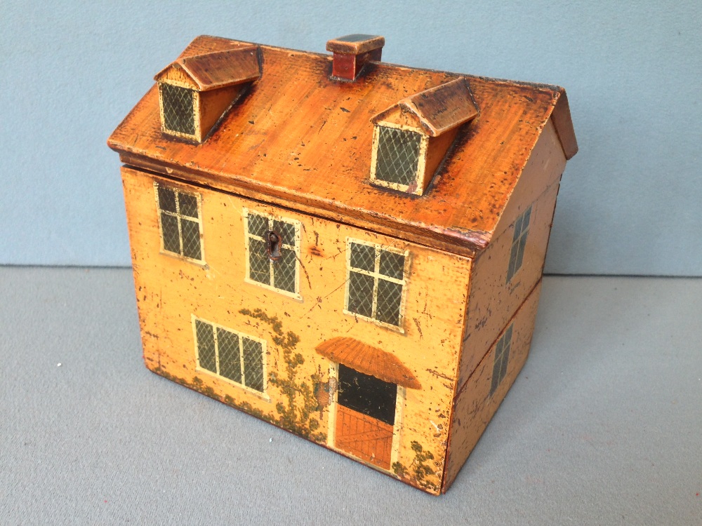 A finely painted Naive early Victorian sewing box, in the form of a cottage
The hinged lid enclosing