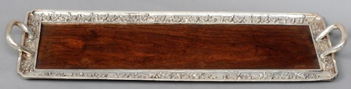 An early 20th century Japanese Sterling silver mounted hardwood tray
Of elongated rectangular form