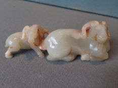A Chinese carved jade group
Modelled as two recumbent goats.  11 cms long.   CONDITION REPORTS: