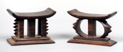 Two African carved hardwood miniature head rests
Each with dished top supported on carved and