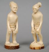 A pair of African carved ivory figures
Modelled standing with tribal hair style and traditional