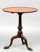 A 19th century mahogany wine table
The circular tilt-top with pie crust edge, supported on a