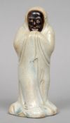 A 19th century Oriental celadon ground figure
Modelled as a dark gentleman in a continuous robe.  19