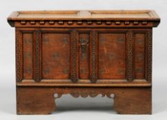 A 17th/18th century oak coffer, probably Spanish
The panelled top above a dentil moulded frieze