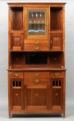 A pair of Continental Arts & Crafts cabinets
Each moulded rectangular cornice above a stained leaded