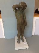A bronze figure of a scantily clad youth
Modelled standing wiping a tear from his eye, later mounted