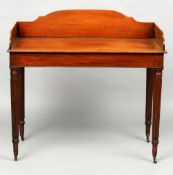 An early 19th century mahogany washstand
The shaped three quarter galleried top above a plain