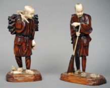 A pair of late 19th century Japanese carved ivory and wooden peasant figures
One holding a broom,