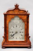 A Victorian burr walnut and rosewood cased twin fusee mantel clock
The scrolling domed case