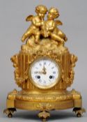A 19th century French ormolu mantel clock
The white enamelled dial with Roman and Arabic numerals