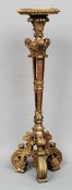 A late 19th century giltwood torchere
The gadrooned hexagonal top above the ornately scroll carved