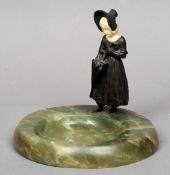 An early 20th century ivory and bronze figurine
Formed as a young girl opening an umbrella,
