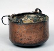 A 17th/18th century copper pan
With a beaten wrought iron swing handle and suspension loop.  19