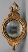 A Regency giltwood convex wall mirror
With rope twist borders, surmounted with a hippocanth.  125