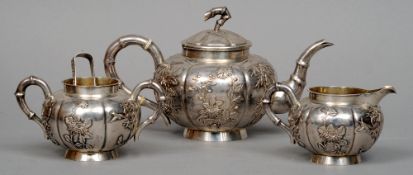 A three piece Chinese silver tea set, maker's mark of Zee Wo
Each piece of squat segmented form with