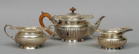 A Victorian and later matched three piece silver tea service, hallmarked London 1897 and 1913,