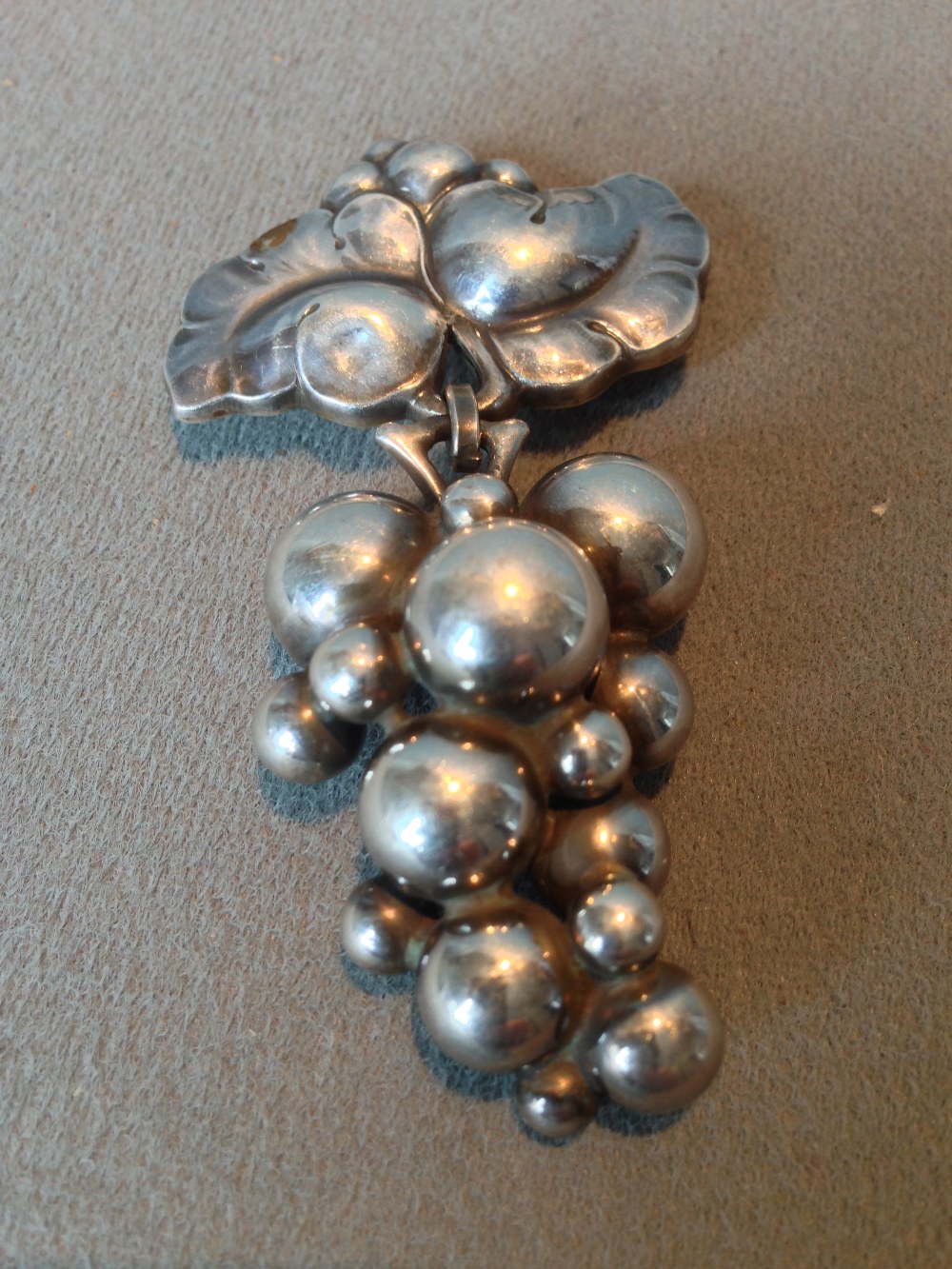 A George Jensen silver pendant brooch
Formed as a bunch of grapes, the reverse stamped 925 Denmark.