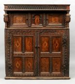 A 17th century and later oak court cupboard
The arcaded frieze above a pair of line inlaid and