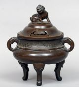 An 18th century Chinese bronze censor
The pierced domed cover surmounted with a dog-of-fo, the