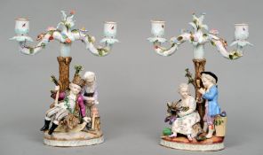 A pair of 19th century Continental figural candelabra
Each with twin branches with floral