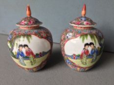 A pair of Chinese porcelain vases and covers
Decorated with figural vignettes, on a floral ground,