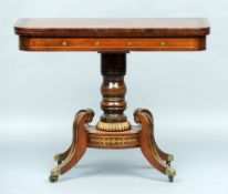 A Regency brass inlaid rosewood card table
The hinged rounded rectangular top above the brass inlaid