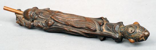 A late 19th century Chinese carved wooden opium pipe
The stem carved as Shao Loa, the bowl with