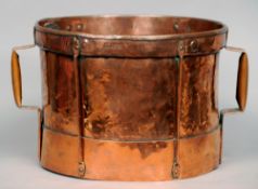 A 19th century Continental copper grain measure
Of drum form with twin loop handles, the rim
