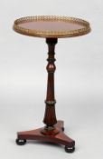 An early 19th century mahogany tripod table
The pierced brass galleried top above a turned and