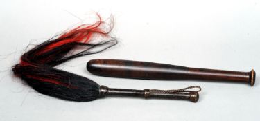A late 19th/early 20th century African fly whisk
With a plaited leather handle; together with a