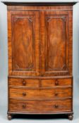 An early 19th century mahogany bow fronted linen press
The moulded cornice above twin doors with